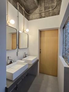 a bathroom with two sinks and a wooden door at Mikasakan - Vacation STAY 18148 in Kinokawa