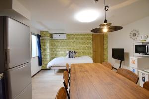 a kitchen and dining room with a table and a bed at Hostel In Kyoto Gion - Vacation STAY 13469v in Gionmachi
