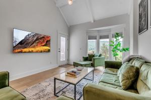 a living room with two couches and a table at Family Friendly Spacious Townhome Across From Holiday Valley in Ellicottville