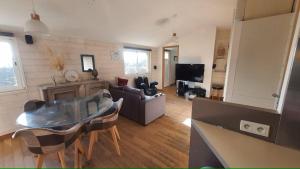 a living room with a couch and a table in a room at Les pléiades in Lamballe Armor