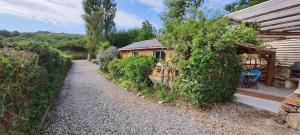 a house with a gravel path next to a building at Les pléiades in Lamballe Armor