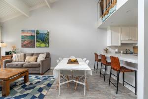 a kitchen and living room with a table and chairs at Rare 2 Bedroom & Loft Townhouse on the North Shore in Kahuku