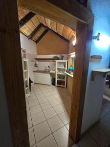 a kitchen with an open door to a room with a counter at The Big Rondawel in Marloth Park +7 photos