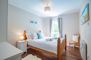 a bedroom with a bed and a window at City Townhouse with parking in Galway