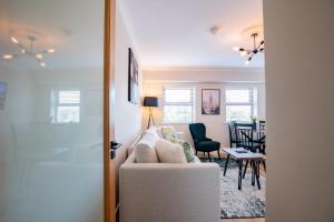 a living room with a couch and a dining room at Seanáras Beag in Galway