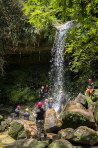 a group of people standing in front of a waterfall at Ixora travel in Acacías