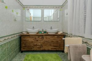a bathroom with two sinks and a mirror at House Lucic in Zaton +21 photos