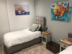 a bedroom with a bed and a painting on the wall at Ville Verde in Loulé +22 photos