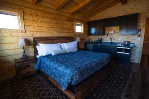 ein Schlafzimmer mit einem Bett in einer Holzhütte in der Unterkunft Muddy Creek Mining Company in Hanksville