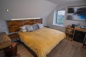 a bedroom with a bed with a yellow blanket at Magnolia House, Rye in Rye