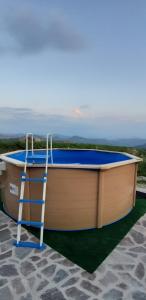 a ladder standing next to a boat with a pool at CASCINA BINELLO appartamenti A & B in Belvedere Langhe