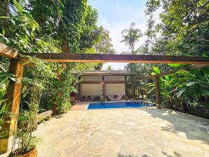 an external view of a house with a swimming pool at Rua Borba Gato Nº 115 · Casa da Mata - An Experience Amidst Nature in São Sebastião