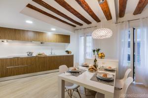 a kitchen and dining room with a table and chairs at Center Pamplona Apartment UAT00537 in Pamplona