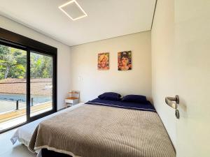 Ένα ή περισσότερα κρεβάτια σε δωμάτιο στο Casa Rubi C/ jacuzzi E Quiosque privativo na praia