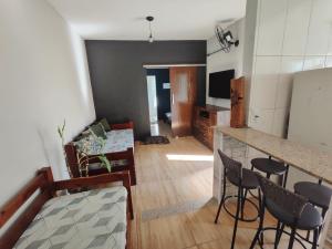a living room with a bar and a kitchen at Villa Caiçara in Ubatuba