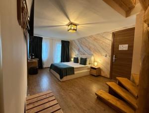 a hotel room with a bed and a window at Conacul Radacinilor in Petroşani