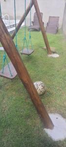 a playground with swings and a ball on the grass at CASA DUPLEX EM PENEDO 4 SUÍTES,FINS DE SEMANA e FERIADOS in Itatiaia