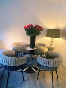 a table and two chairs with a vase of flowers on it at Wohngut City Appartement 4 für 1-4 Personen inklusive Parkplatz in Hagen