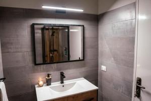 a bathroom with a sink and a mirror at Tropical Suite 22 A in Santa Maria +18 photos
