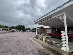 a parking lot with a truck parked in a garage at Siesta Motel in Mitchell