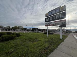 a sign for a motel on the side of a highway at Siesta Motel in Mitchell