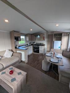 a living room with a couch and a table at Swift Loire Holiday Home sleeps 6 Haven Littlesea in Weymouth