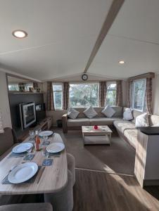 a living room with a couch and a table at Swift Loire Holiday Home sleeps 6 Haven Littlesea in Weymouth