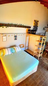 a bedroom with a large bed and a shelf at Quincholoftmdq monoambiente con cochera in Mar del Plata