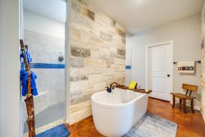 a bathroom with a large white tub and a shower at Family-Friendly Johnson City Home Near State Parks in Hye +25 photos