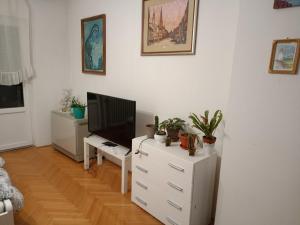 a living room with a television and a white dresser at Kleopa in Pale