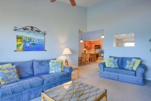 a living room with blue couches and a table at Oceanfront Resort - Swimming Pool - Tennis in Chadwick Acres
