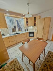 a large kitchen with a wooden table and chairs at Alfeld City Apartment in Alfeld +19 photos