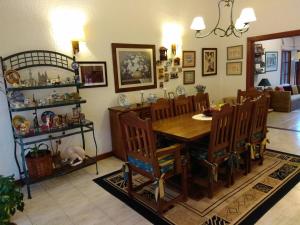 a dining room with a wooden table and chairs at Chalet ALTOS DEL PINAR in Punta del Este