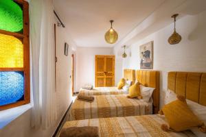 Postel nebo postele na pokoji v ubytování Riad Orient Palace