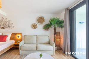 a living room with a bed and a chair at Studio Alamanda Baie Orientale in Orient Bay