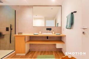 a bathroom with a sink and a mirror at Studio Alamanda Baie Orientale in Orient Bay