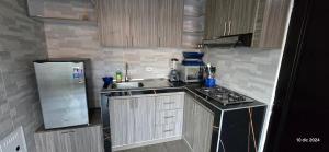 a small kitchen with a sink and a stove at Apartamento con parqueadero y piscina in Ibagué