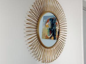 a gold mirror on a wall with a painting at Millbrook Blues 2BR Entire Home in Middlesbrough