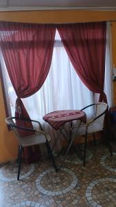 two chairs and a table in front of a window at Hostal Open House in San Pedro de Atacama +92 photos