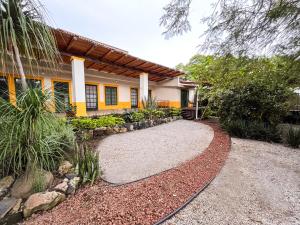 a house with a gravel driveway in front of it at Shanti Home in Tepoztlán