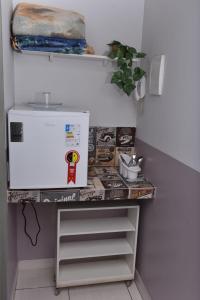 a shelf in a room with some food on it at Casa da Vó Maria 10 in Goiânia