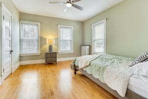a bedroom with a bed and a ceiling fan at Ski, Hike and Fish Modern Rutland Home in Rutland