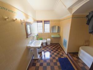 a bathroom with a sink and a toilet and a tub at 169 Forbury Road in Dunedin