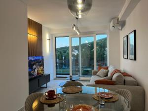 a living room with a couch and a table at Yves Lake Front Apartments in Ohrid