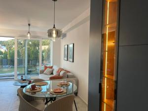 a living room with a table and a couch at Yves Lake Front Apartments in Ohrid