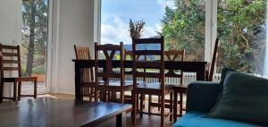 a living room with a table and chairs and a window at Haus Panorama mit Alpenblick in Kleines Wiesental