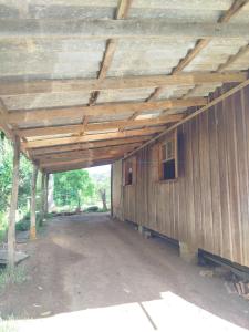 a large wooden building with a wooden roof at Quarto Cama Casal in Gramado
