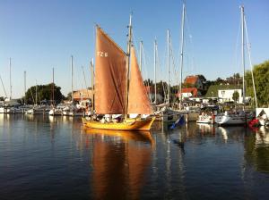 a small sail boat in a marina with other boats at Pension Am Klünderberg in Binz