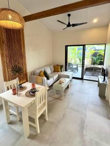 a living room with a couch and a table at Private Tail House centre Uvita in Uvita +27 photos