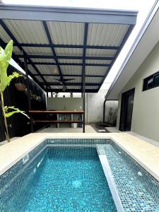 a swimming pool in the middle of a house at Private Tail House centre Uvita in Uvita